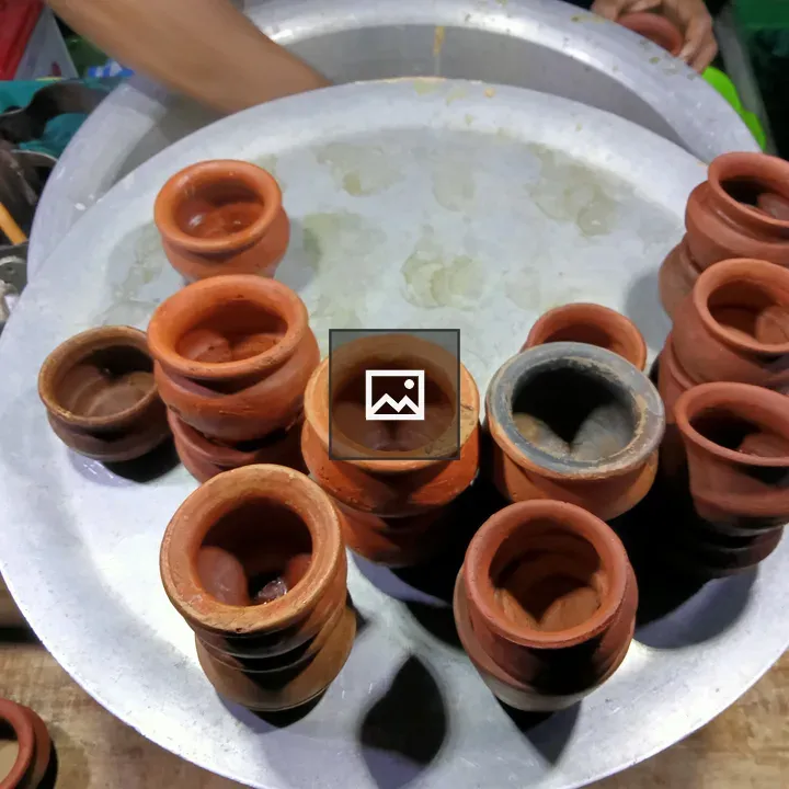 Clay cups and dishware on tray