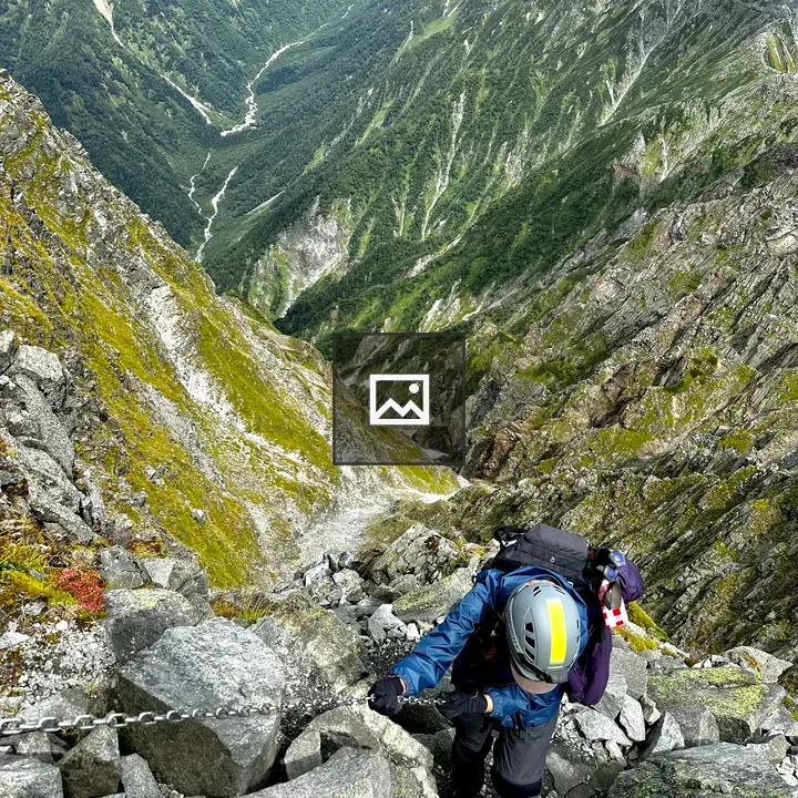 Female hiker on steep mountain ascent