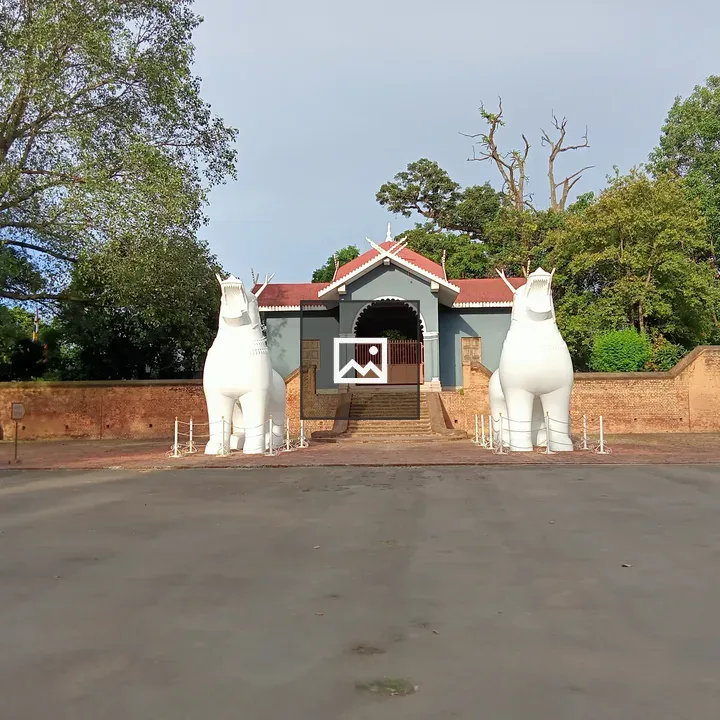 Blue Building with Red Roof and White Statues
