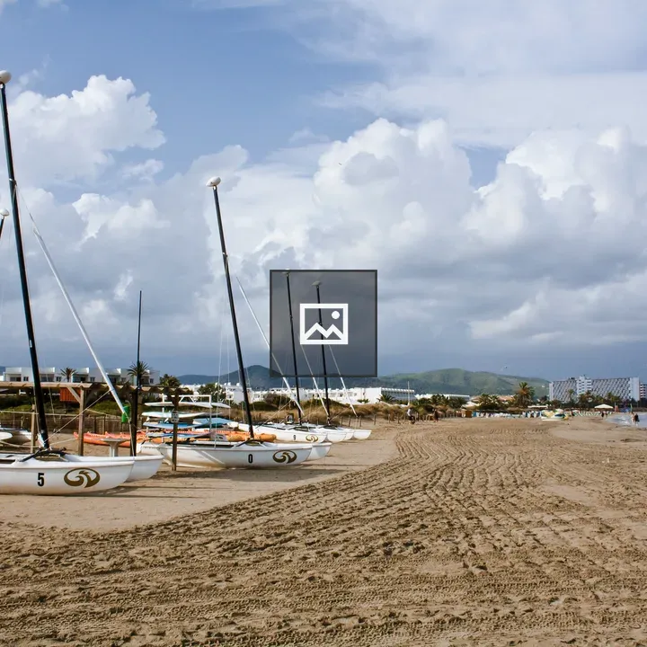 Cloudy beach with boats