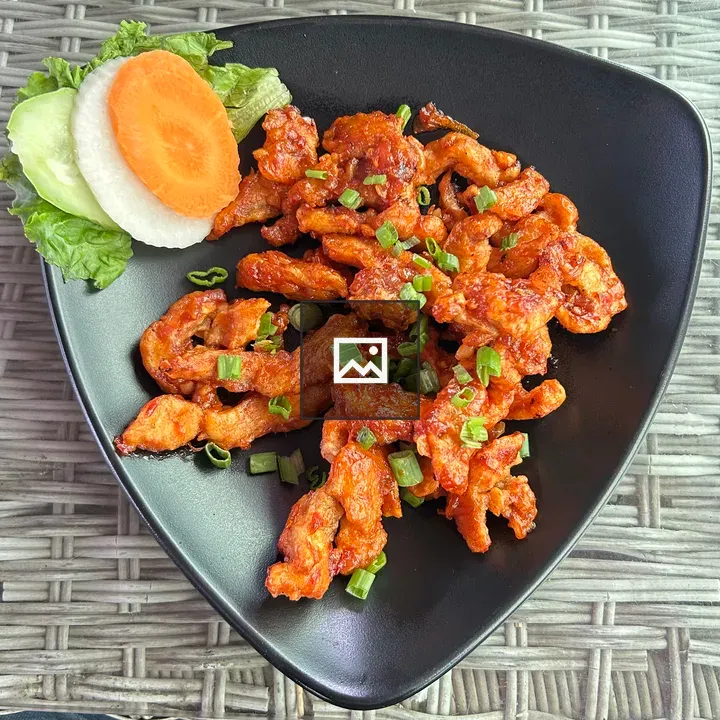 Spicy chicken strips on plate