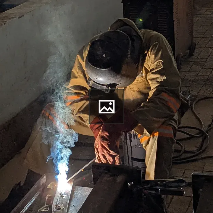 Close of a factory worker welding