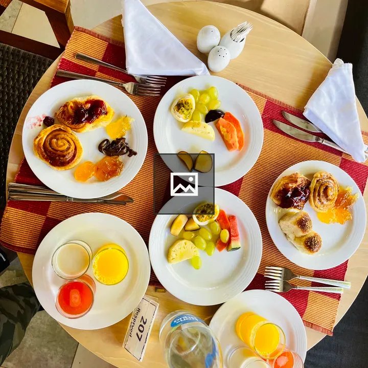 Round wooden table with breakfast spread