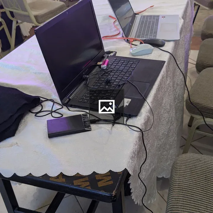 Table with Open Laptops and Stage Background