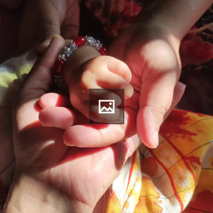 Hands Intertwined: Child and Adult