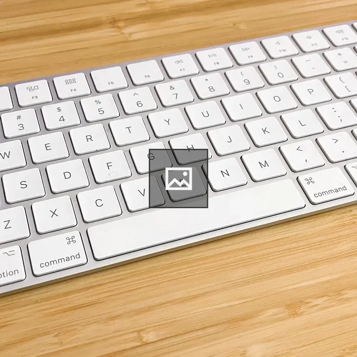 White keyboard on bamboo desk