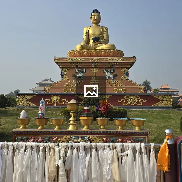 Buddha statue with scarves and offerings
