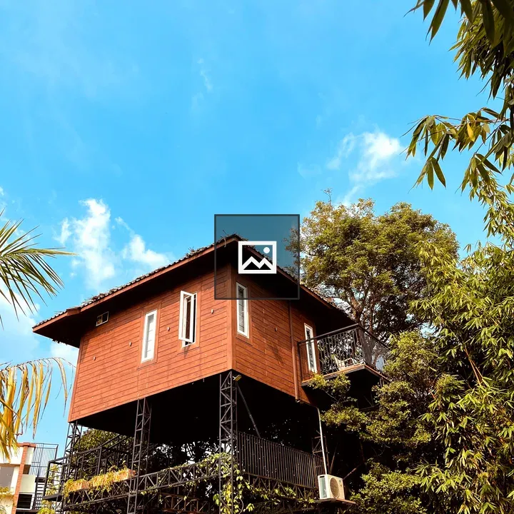 Building on stilts among trees