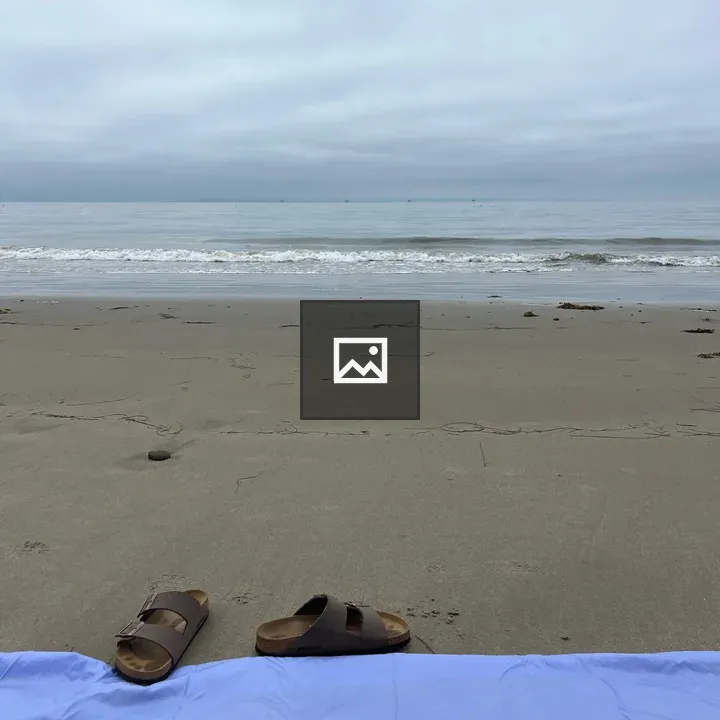Sandy Beach with Towels and Sandals