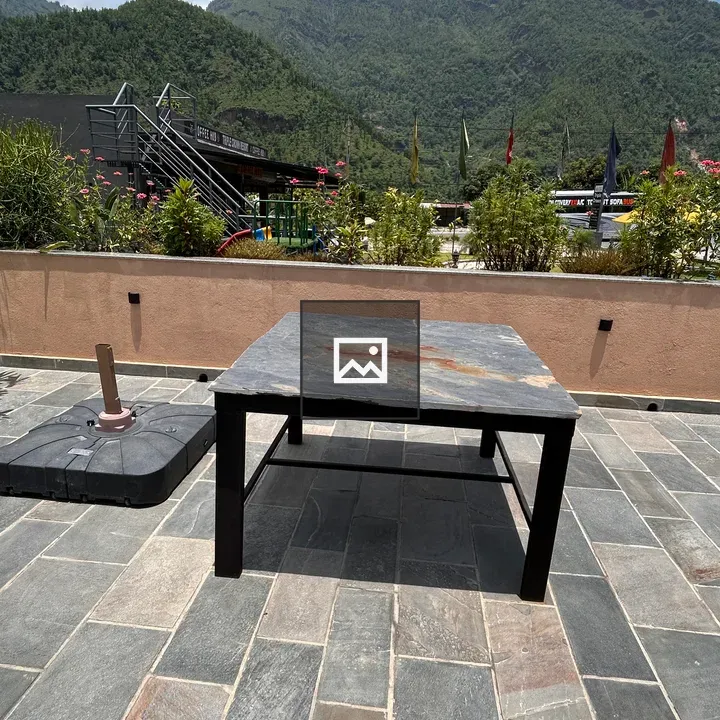 Black Stone Table on Patterned Patio