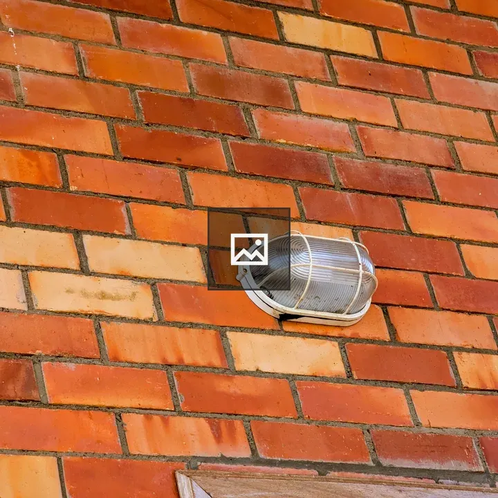 Outdoor light fixture on brick wall