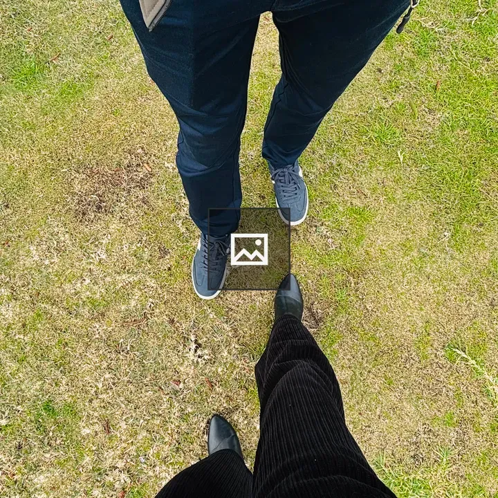 Couple Standing on Green Grass