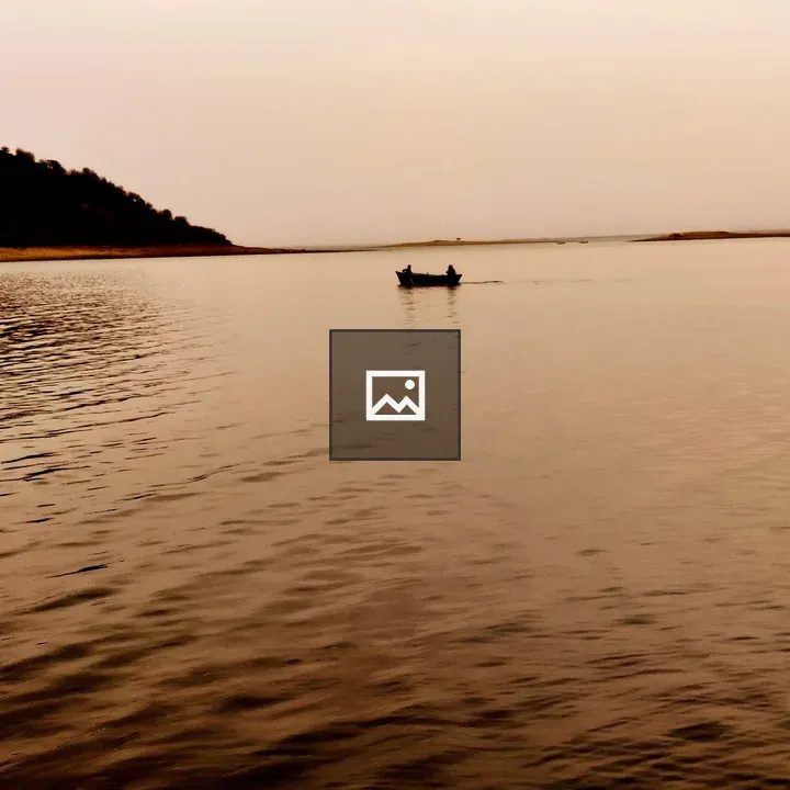 Two people in a boat at sunset