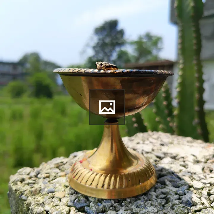 Brass Bowl on Rock Surface