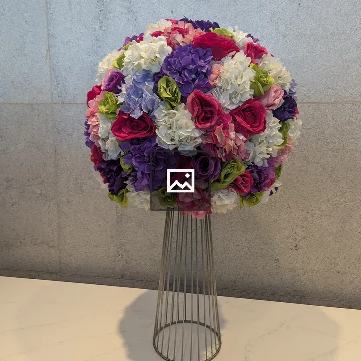 Round floral arrangement on pedestal
