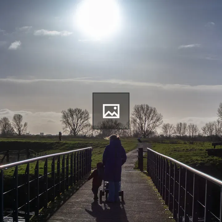 Woman and child on a sunny bridge