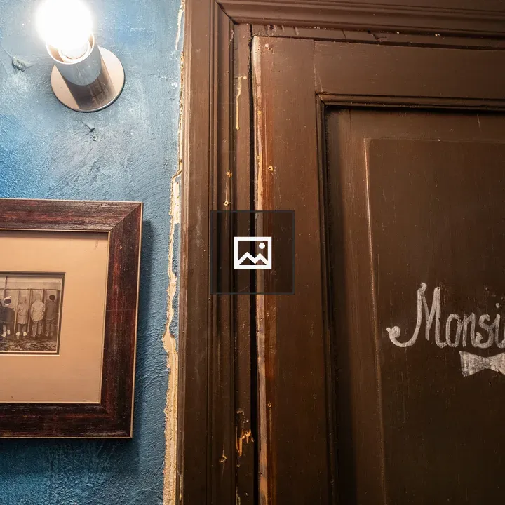 Monsieur sign in brown door