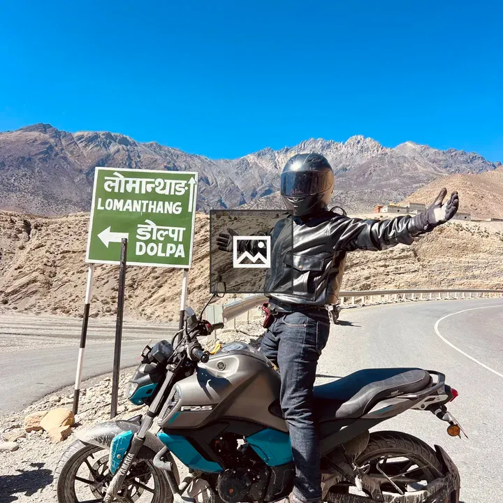 Person on motorcycle with sign