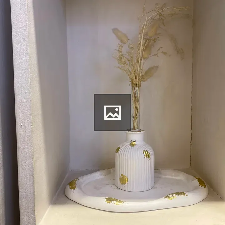 White ribbed vase with dried grass