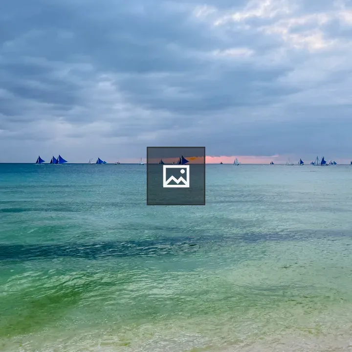 Ocean view with blue sailboats