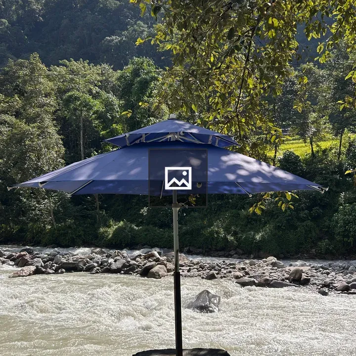 Blue umbrella on riverbank