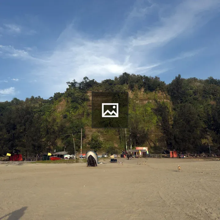 Beach with Sand, Hill, and Stalls