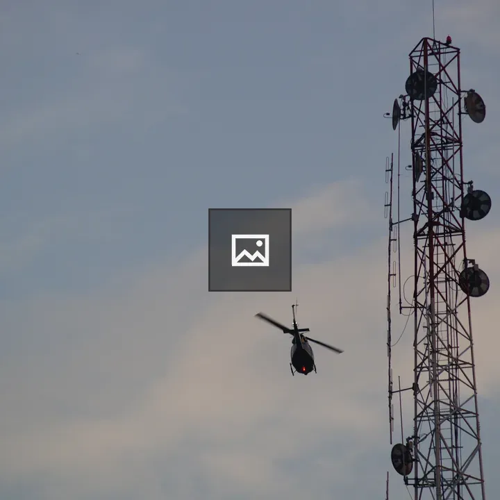 Helicopter Passing a Tower