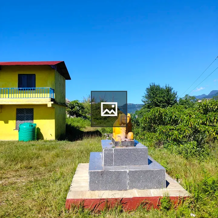 Yellow House with Red Roof and Nandi Statue