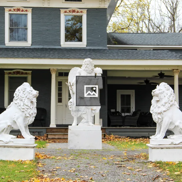 Lion Statues and Neptune Outfit Front Yard