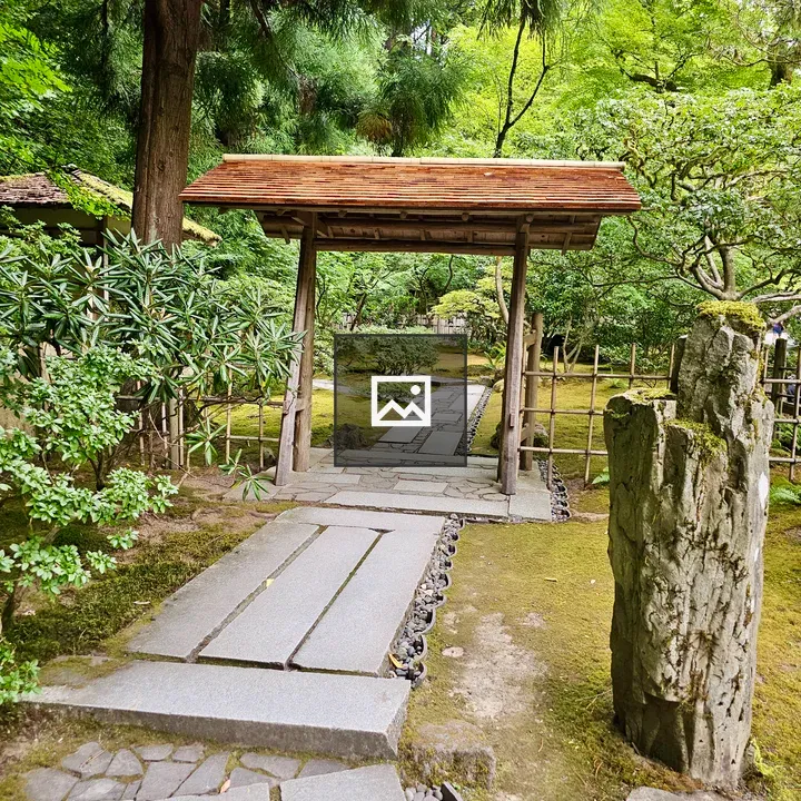 Wooden garden gate with stone path