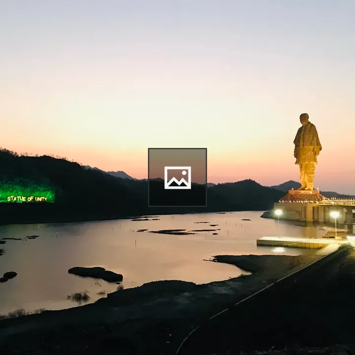 Statue by Lake and Sky