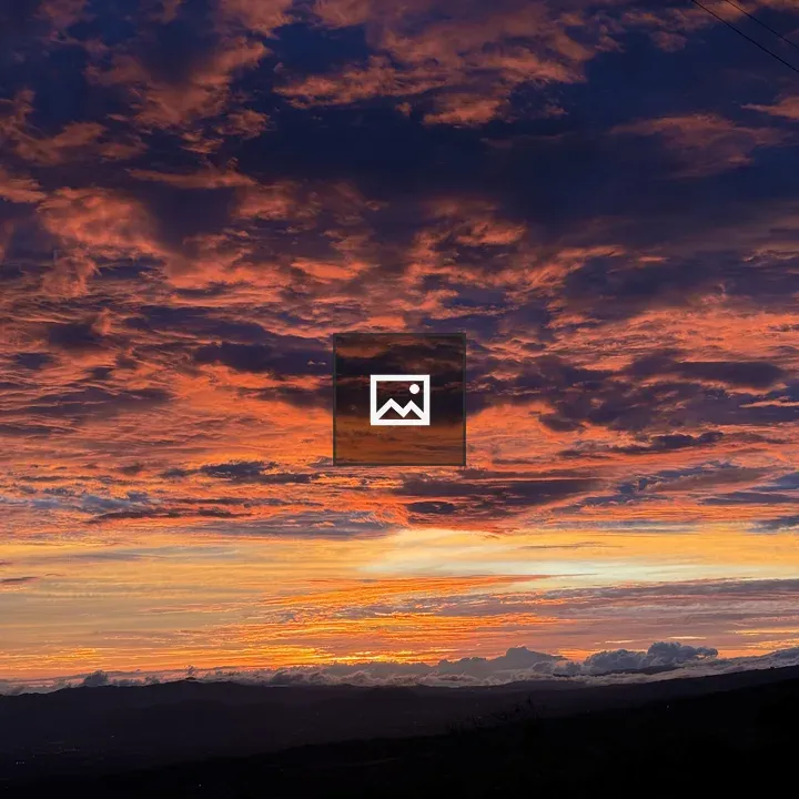 Dramatic Sunset Sky Over Distant Landscape