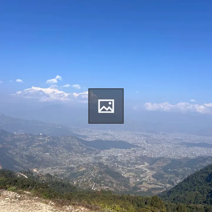 Hilly landscape with snow-capped mountains