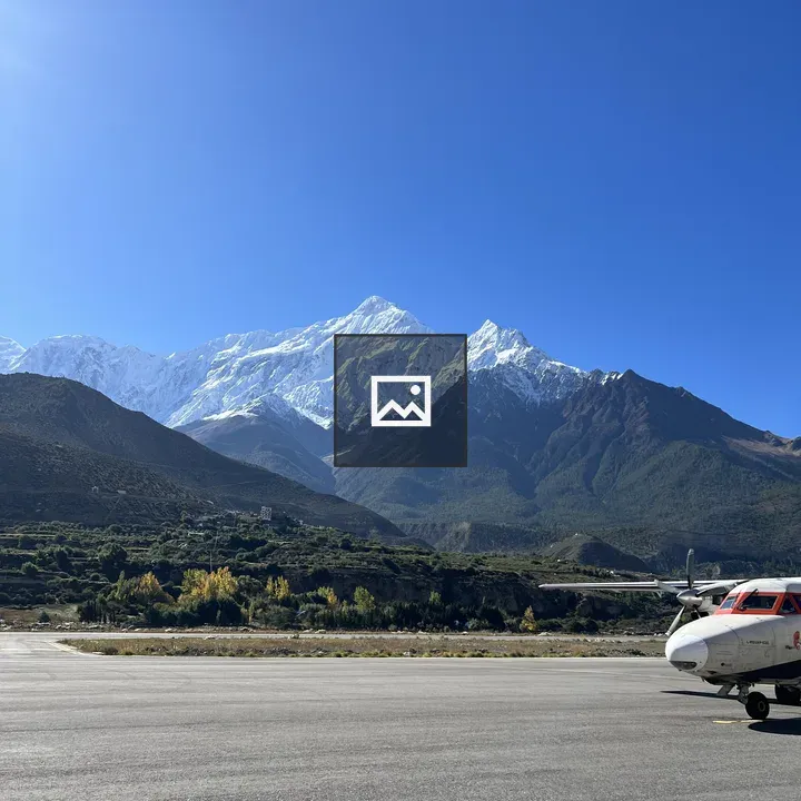 Airplane on Tarmac with Mountain Range