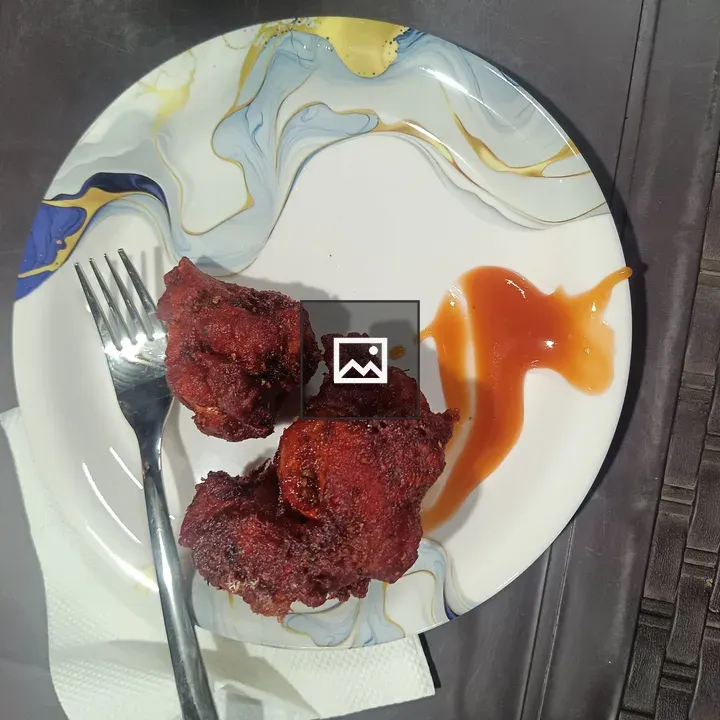 Plate of fried chicken with orange sauce