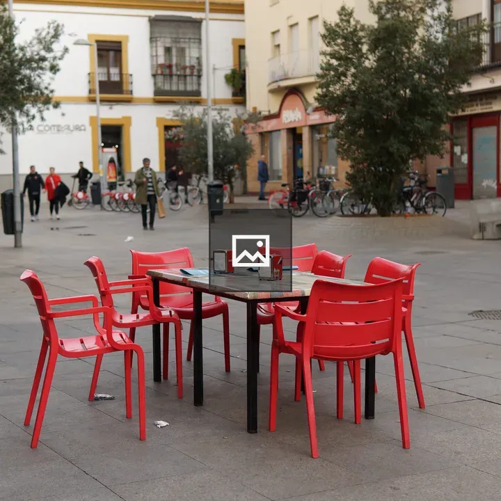 Table and red chairs at street bar