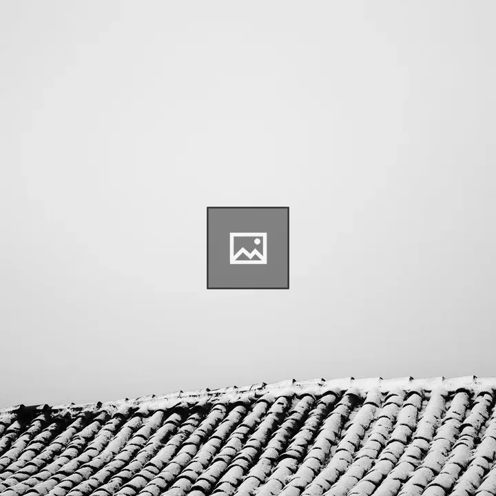 Sagging tiled roof with snow