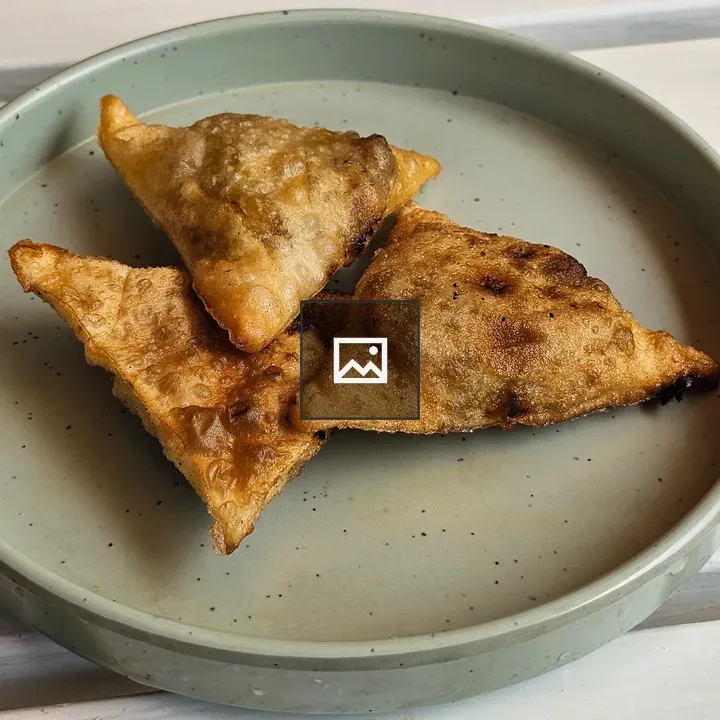 Three samosas on plate