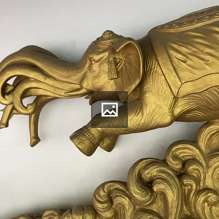 Elephant sculpture with ornate head decorations