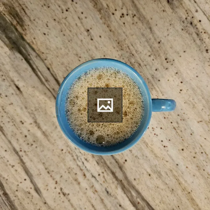 Cup of frothy tea on table