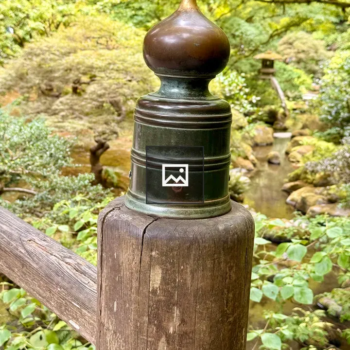 Decorative bronze cap on post