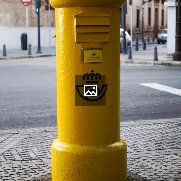 Bright yellow mailbox on street