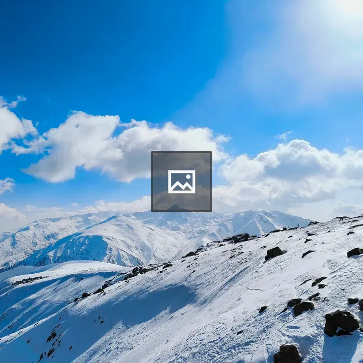 Snowy Peaks Under Sunny Skies