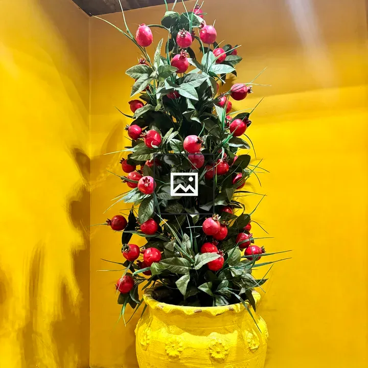 Decorative artificial plant in a yellow planter