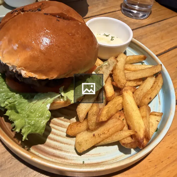 Hamburger with fries on blue plate