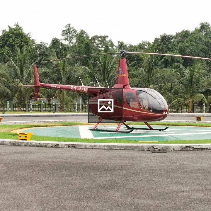 Red helicopter on helipad