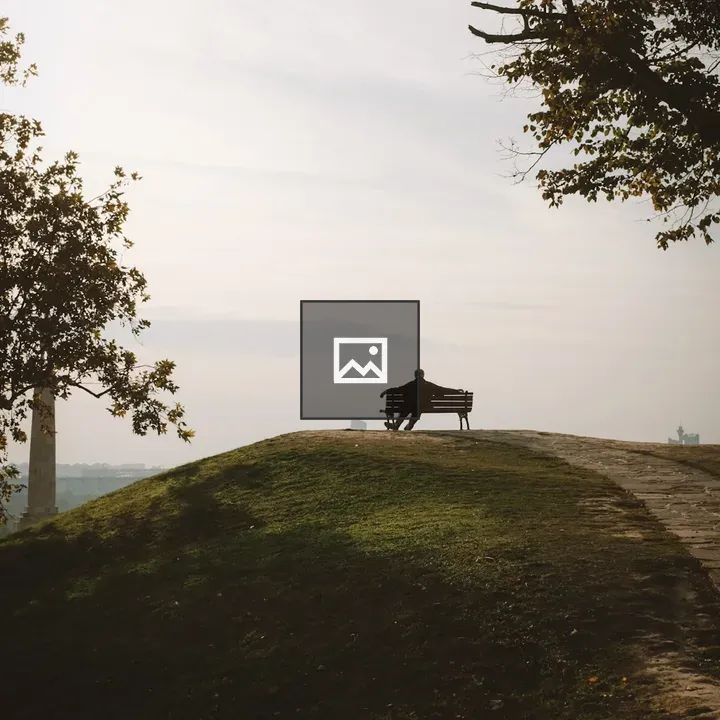 Person on hillside bench overlooking city
