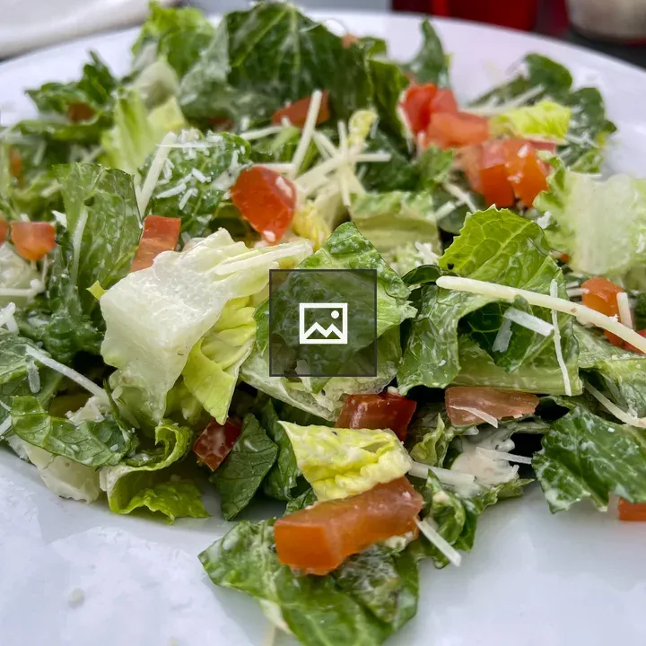 Caesar salad dish with tomatoes