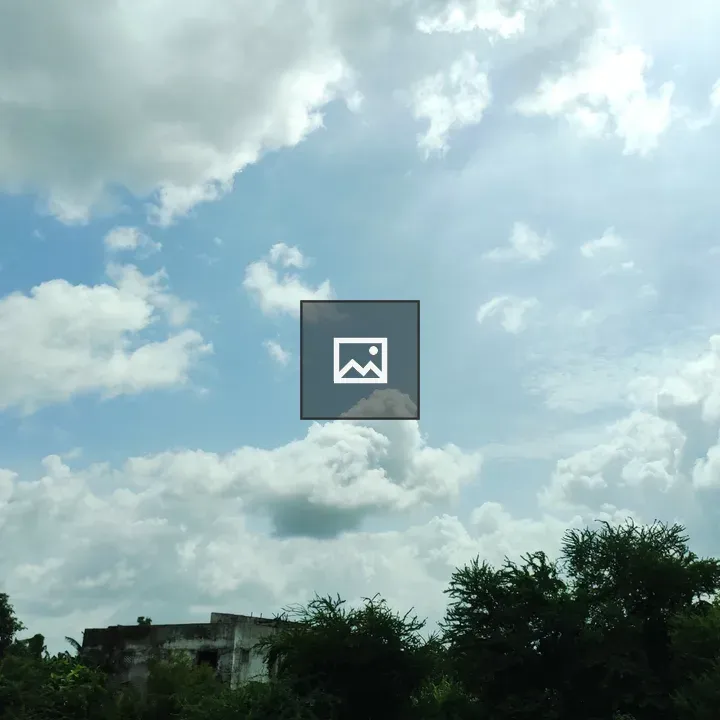 Broken clouds over green landscape