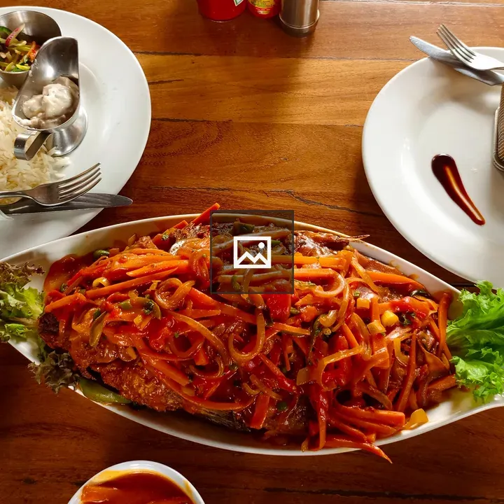 Whole fried fish on table